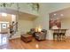 Open-concept living room with hardwood floors, staircase, and adjacent kitchen bar area at 119 Marykirk Pl, Garner, NC 27529