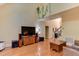 Open living room with hardwood floors, media center, stairs, and high ceilings at 119 Marykirk Pl, Garner, NC 27529