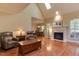 Bright living room with hardwood floors, vaulted ceilings, fireplace, and ample natural light at 119 Marykirk Pl, Garner, NC 27529