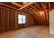 Unfinished room with exposed beams, one window, and an unfinished floor at 119 Marykirk Pl, Garner, NC 27529