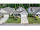 An aerial view of a well-maintained home with a manicured lawn and mature trees in a residential neighborhood at 120 Bramble Ln, Clayton, NC 27527