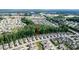 Beautiful aerial view of homes in Flowers Crossroads neighborhood with lush greenery and a pond nearby at 120 Bramble Ln, Clayton, NC 27527
