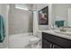 Bright bathroom featuring a bathtub with gray tile surround and vanity with dark cabinets at 120 Bramble Ln, Clayton, NC 27527