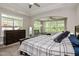 Bright bedroom featuring tray ceiling, dark wood furniture, and a sitting area with lots of natural light at 120 Bramble Ln, Clayton, NC 27527
