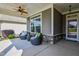 Relaxing front porch featuring comfortable wicker seating, a ceiling fan, and stylish decor at 120 Bramble Ln, Clayton, NC 27527