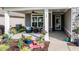 Inviting front porch with seating, potted plants, and decorative accents creating a welcoming entrance at 120 Bramble Ln, Clayton, NC 27527