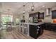 Modern kitchen boasts a spacious island, stainless appliances, and sleek dark cabinetry at 120 Bramble Ln, Clayton, NC 27527