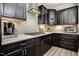 Well-equipped kitchen with dark cabinetry, a gas cooktop, and ample counter space at 120 Bramble Ln, Clayton, NC 27527