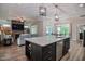 Open-concept kitchen with a center island and stainless steel appliances, flowing into the living area at 120 Bramble Ln, Clayton, NC 27527