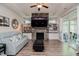 Bright living room featuring a stone fireplace, built-in shelving, and cozy furnishings at 120 Bramble Ln, Clayton, NC 27527