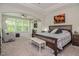 Spacious main bedroom with a tray ceiling, large windows, and a connected office at 120 Bramble Ln, Clayton, NC 27527