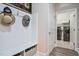 Mudroom featuring a bench with storage, hat hooks, and a view to the laundry room at 120 Bramble Ln, Clayton, NC 27527