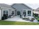 Spacious patio with outdoor seating, dining area, and lush green lawn at 120 Bramble Ln, Clayton, NC 27527