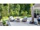 Patio area featuring comfortable seating with plush cushions and a view of the green landscape at 120 Bramble Ln, Clayton, NC 27527