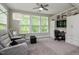 Relaxing sitting area featuring built-in shelving, a ceiling fan, and large windows offering plenty of natural light at 120 Bramble Ln, Clayton, NC 27527
