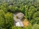 Aerial perspective of the property showcasing the home and surrounding wooded landscape at 121 Pheasant Ct, Pittsboro, NC 27312