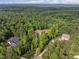 Estate home surrounded by mature trees and lush foliage, providing an idyllic setting at 121 Pheasant Ct, Pittsboro, NC 27312