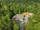 A well-maintained home with a private driveway and large barn, surrounded by dense woods at 121 Pheasant Ct, Pittsboro, NC 27312