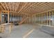 Unfinished basement featuring wood framing, staircase, and radiant floor heating at 121 Pheasant Ct, Pittsboro, NC 27312