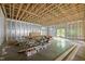 Spacious unfinished basement with exposed wood framing, radiant floor heating and walkout access at 121 Pheasant Ct, Pittsboro, NC 27312