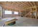 Unfinished basement with exposed framing, radiant floor heating, and window openings at 121 Pheasant Ct, Pittsboro, NC 27312