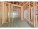Unfinished bathroom with exposed framing, radiant floor heating, and plumbing for a shower at 121 Pheasant Ct, Pittsboro, NC 27312