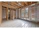 Unfinished bedroom with exposed wood framing, subfloor, and a window at 121 Pheasant Ct, Pittsboro, NC 27312