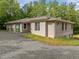 View of home exterior with a gravel driveway, partial shingle and partial stucco at 121 Pheasant Ct, Pittsboro, NC 27312