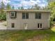 Rear exterior showcasing basement entrance, windows, and bay window at 121 Pheasant Ct, Pittsboro, NC 27312