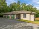 View of home exterior with a gravel driveway, partial shingle and partial stucco at 121 Pheasant Ct, Pittsboro, NC 27312