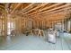 Spacious living room under construction with exposed wooden framing and radiant floor heating system at 121 Pheasant Ct, Pittsboro, NC 27312