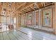 Unfinished living room showcasing the framing, radiant floor heating, and natural light from the windows at 121 Pheasant Ct, Pittsboro, NC 27312