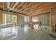 Unfinished living space with exposed wood framing, subfloor and large windows at 121 Pheasant Ct, Pittsboro, NC 27312