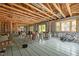 Unfinished living space with exposed wood framing, subfloor, and a large window at 121 Pheasant Ct, Pittsboro, NC 27312