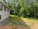 Side yard showing the rear wall of a home under construction and wooded area at 121 Pheasant Ct, Pittsboro, NC 27312