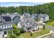 Aerial view showcases a neighborhood with well-maintained lawns and houses at 122 Swansboro Ln, Chapel Hill, NC 27516