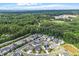 An aerial view of a new development with houses, trees, and a pond at 122 Swansboro Ln, Chapel Hill, NC 27516