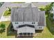 Aerial view of a home with a gray roof and screened-in porch, backing up to the street at 122 Swansboro Ln, Chapel Hill, NC 27516