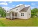 Backyard view of house featuring screened-in porch at 122 Swansboro Ln, Chapel Hill, NC 27516
