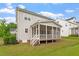 Backyard view of house featuring screened-in porch and stairs at 122 Swansboro Ln, Chapel Hill, NC 27516