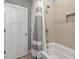 Bathroom featuring tub and shower combo with neutral beige tile at 122 Swansboro Ln, Chapel Hill, NC 27516