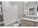 Bright bathroom featuring a shower over bath, patterned tile floor and a vanity unit at 122 Swansboro Ln, Chapel Hill, NC 27516