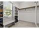 Walk-in closet with natural light, shelving and bench at 122 Swansboro Ln, Chapel Hill, NC 27516