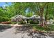 View of community clubhouse with mature landscaping at 122 Swansboro Ln, Chapel Hill, NC 27516