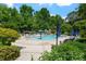 Beautiful community pool area with seating and umbrellas, perfect for relaxation and recreation at 122 Swansboro Ln, Chapel Hill, NC 27516