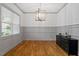 Dining room featuring hardwood floors, a large window and modern lighting fixture at 122 Swansboro Ln, Chapel Hill, NC 27516