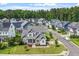Charming two-story home featuring a stone facade, gray shingles, and a beautifully landscaped front yard at 122 Swansboro Ln, Chapel Hill, NC 27516