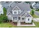 Charming two-story home with stone accents, a covered porch, and a well-manicured lawn at 122 Swansboro Ln, Chapel Hill, NC 27516