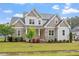 Charming two-story home with a combination of stone and siding, landscaped yard, and inviting front porch at 122 Swansboro Ln, Chapel Hill, NC 27516