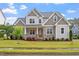 Charming two-story home featuring stone accents, manicured lawn and mature landscaping at 122 Swansboro Ln, Chapel Hill, NC 27516